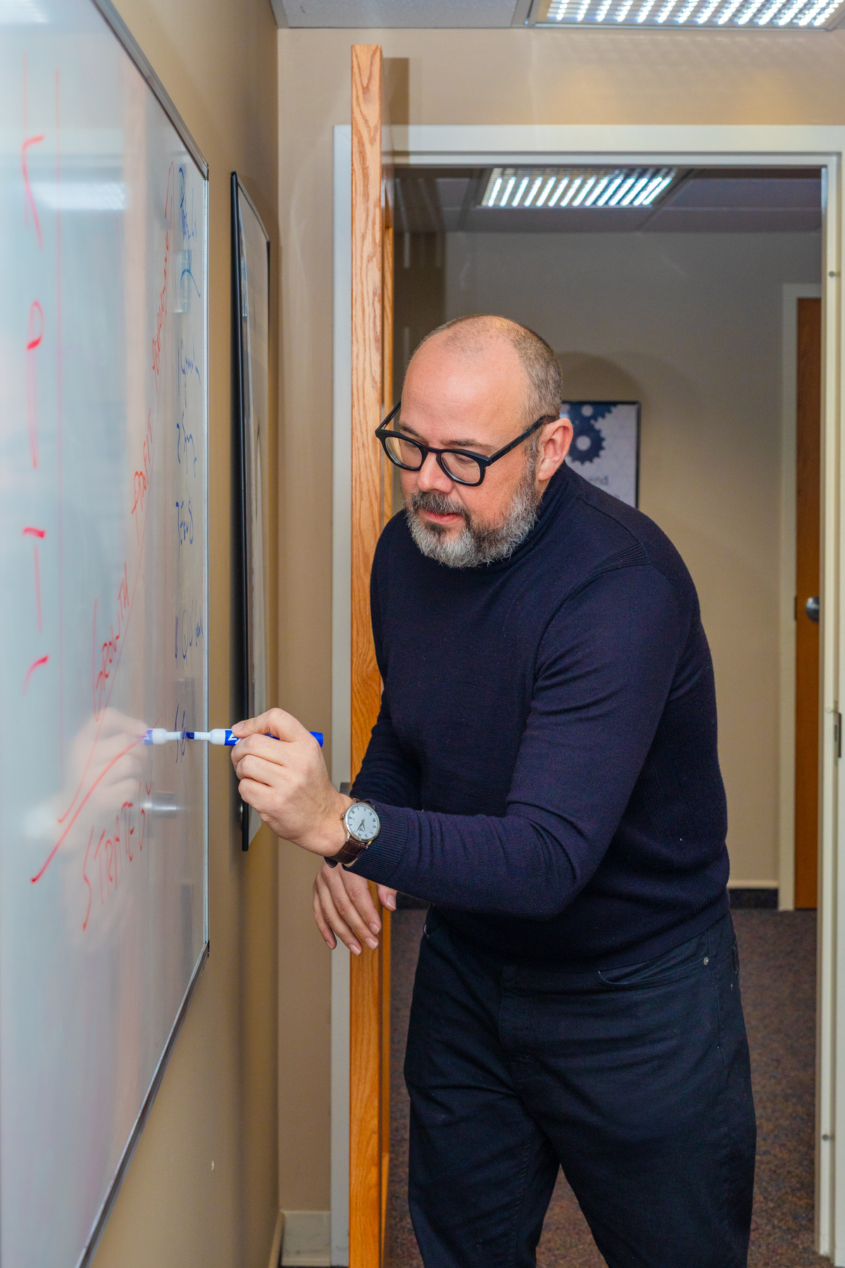 marketing director writing on a dry erase white board